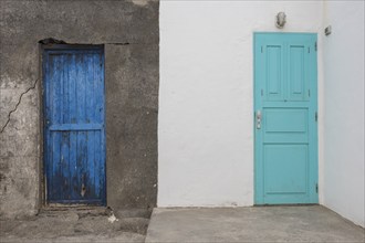 Two contrasting doors, one blue and the other turquoise, in a wall, Canary Islands, Lanzarote,