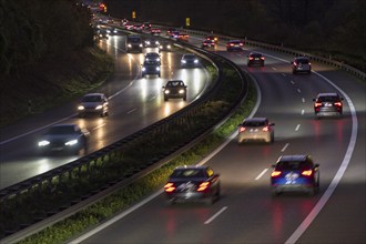 Busy motorway at night with light trails of fast-moving cars under artificial lighting, Rems-Murr