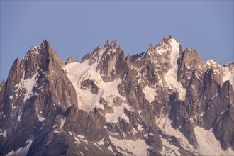 Evening mood with pink evening sky, mountain landscape at sunset, pointed mountain peaks Aiguille