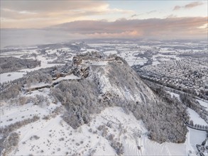 Aerial view of the snow-covered Hegau volcano Hohentwiel with Germany's largest castle ruin on a