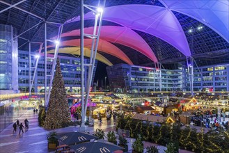 Christmas market at the airport in the evening, market stalls decorated for Christmas in front of