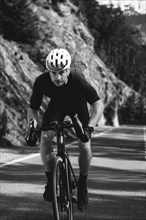 Road bike rider in spring in the Allgäu against the picturesque backdrop of the Alps, Bavaria,