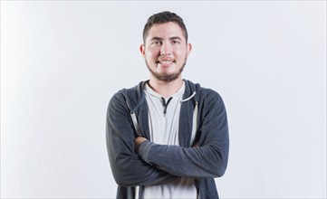 Portrait of handsome latin young man with crossed arms isolated