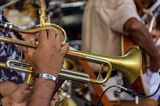 Trumpet player and group of musicians during a musical performance in the streets of Recife,