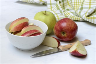 Apple and apple slices in peel, sliced apple with knife