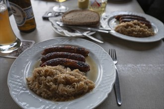 Sausages with sauerkraut and bread served in a Franconian restaurant, Bavaria, Germany, Europe