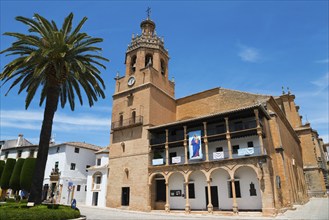 Historic church with bell tower and palm trees under a bright blue sky, Church, once a Moorish