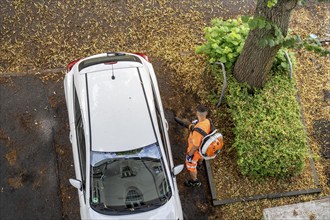 Street cleaning, an employee of the municipal city cleaning service, cleans pavements and parking