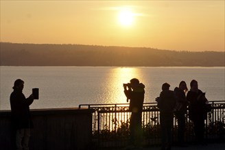 A man and a woman taking photos during sunset, Birnau, 10/10/2021