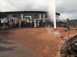 Tourists watch steam rise from geyser spout, Parque Nacional de Timanfaya, national park,