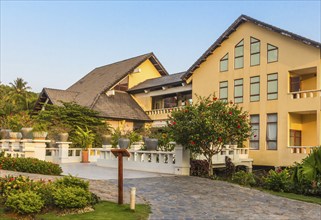 Vietnamese hotel building with garden in the evening