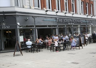 People sitting outside The Joseph Conrad Wetherspoons pub, Lowestoft, Suffolk, England, United