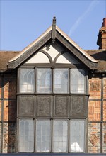 Facade of historic 1925 building heraldic symbols and signs, 105 High Street, Marlborough,