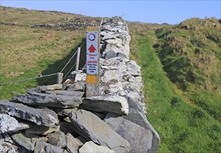 Coastal footpath and sign on cliff path, Cape Clear Island, County Cork, Ireland, Irish Republic,