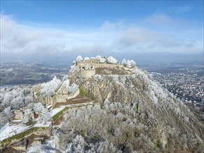 Aerial view of the snow-covered Hegau volcano Hohentwiel with Germany's largest castle ruins,