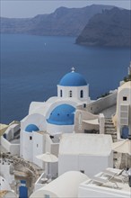 Santorini, Oia, with church Agios Nikolaos, blue dome, Cyclades, Greece, Europe