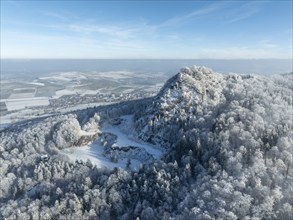 Aerial view of the snow-covered Hegau volcano Hohenstoffeln, with the former basalt quarry,