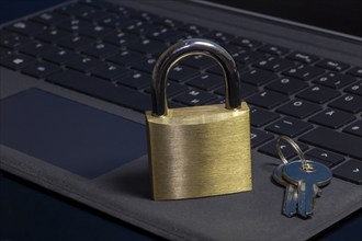 Padlock on a keyboard as a symbolic image for internet security, hacker attacks and so on