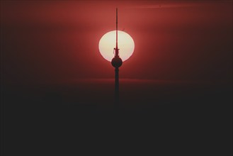 The sunrise emerges behind the city skyline with the television tower in Berlin, 04/09/2024