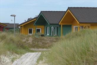 Colourful wooden houses for rent, dune village bungalow, dune of the offshore island of Heligoland,