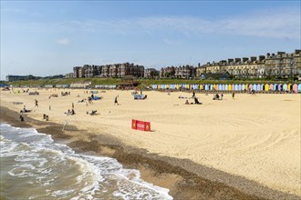 People enjoying sunny weather on sandy South Beach, Lowestoft, Suffolk, England, UK