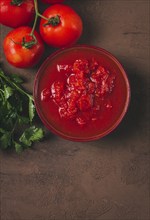 Tomatoes in their own juice, sliced, tomato sauce, tomatoes, in a cup, top view, close-up, no