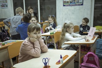 Pupils in a classroom in one of the metro schools in Kharkiv. Classrooms were set up in various