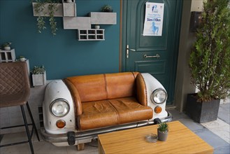 A couch created from the front part of a vintage car stands in a café, Alexandroupoli,