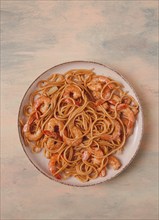 Spaghetti with king shrimps, with spices, top view, selective focus, homemade, no people