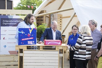 Olaf Scholz (Federal Chancellor, SPD) visits the stand of civil society organisations during a tour