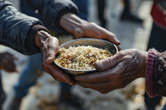 Close up of person's hand holding plate with food at charity food distribution. KI generiert,