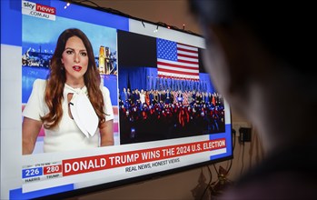 In this photo illustration, a person watch results of U.S. elections on a television in Guwahati,