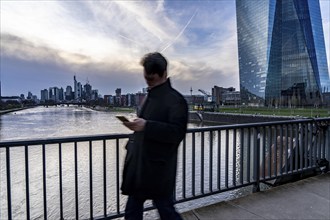 Skyline of Frankfurt am Main, skyscrapers, pedestrians on the Deutschherrnbrücke, ECB building,