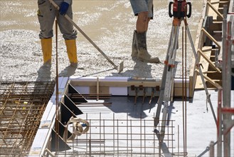 Construction site, concreting, the floor slab of a building is concreted, the concrete is pumped