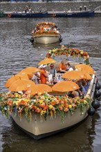 Canal cruise, with flagship organiser, canal boats decorated with flowers, passengers with