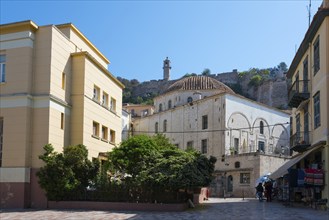 View of historic building with dome and fortress in the background under a clear sky, Agha Pasha