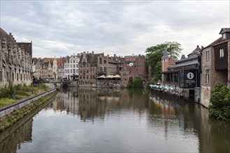 Quiet water canal lined with traditional buildings in Europe, Ghent