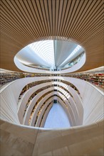 Interior view of a modern library with a spiral structure and wooden design, Zurich, University Law