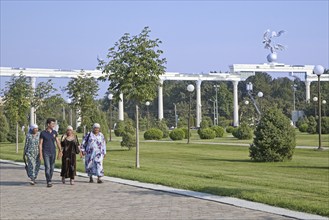 Uzbek women in traditional dress walking through Independence Square in Tashkent, Uzbekistan, Asia