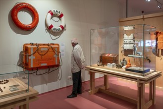 Elderly visitor looking at maritime exhibition at NAVIGO Visserijmuseum, fishery museum at