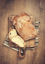 Sliced ciabatta, on a chopping board, italian bread, close-up, Italian cuisine, breakfast, no