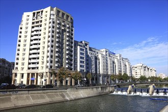 Apartment blocks and office buildings, bank building on the Dambovita River, Bucharest, Romania,