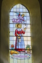 St Notburga, stained glass window, parish church of St Peter and St Paul, Vomp, Inntal, Tyrol,