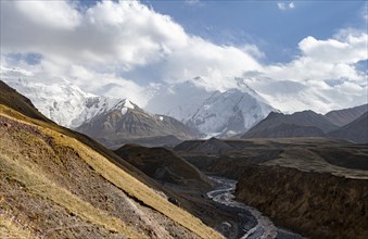 Achik Tash river, Achik Tash valley, behind glaciated and snow-covered mountain peak Pik Lenin,