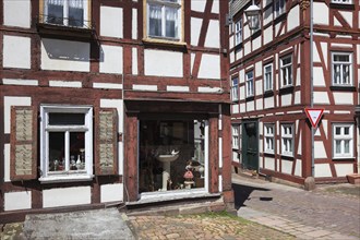 Half-timbered houses in the old town centre, antique shop, Schlitz, small town in the east of the