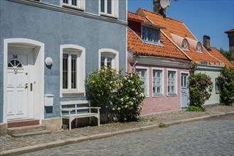 Old houses with roses on a tiny street in the small town of Ystad, Skåne county, Sweden,