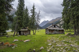 Wooden huts in a green mountain valley, Chong Kyzyl Suu Valley, Terskey Ala Too, Tien-Shan