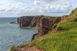 Red coloured sandstone, steep cliff coast of the offshore island of Heligoland, home of the