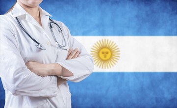 Argentine Health and Care concept. Female doctor holding stethoscope with Argentina flag