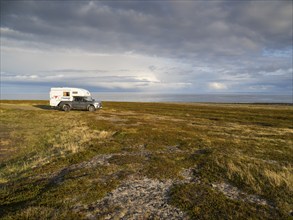 Mobile Camper parked near the Arctic Ocean shore, May, Varanger Fjord, Norway, Europe